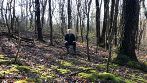 man sitting in woods